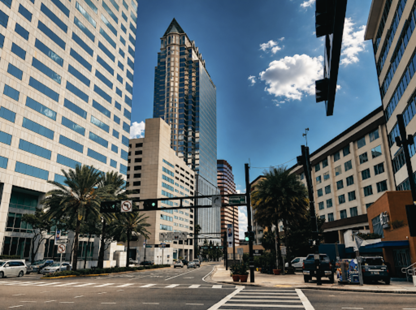 Downtown Tampa street lined with high-rise towers and palm trees